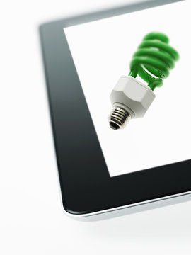 An energy efficient coiled element of a lightbulb coloured green, symbolic of environmental concern, and green energy. 