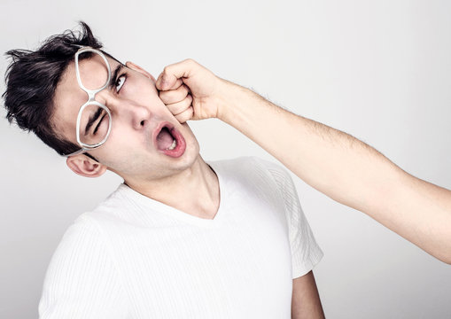 Young Man Getting Punched In The Jaw. Violence And Bulling.