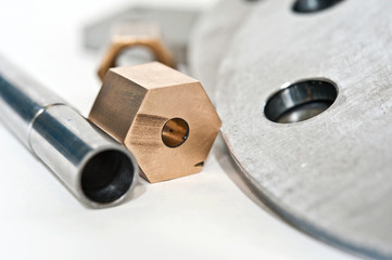 Metal flange pipe and brass nut. Milling and lathe industry