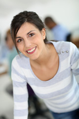 Portrait of cheerful college student in class