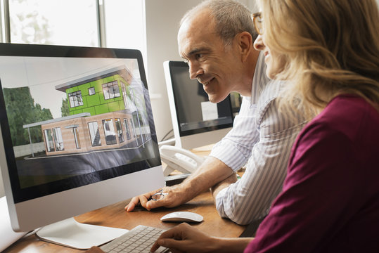 Architects discussing a green construction project, designing and building efficient environmentally friendly buildings. Green architectural practice. 