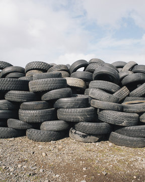 A stack of discarded rubber car tires, collected for recycling, or disposal. 