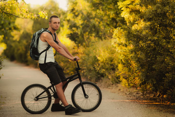 Fototapeta premium Young man sitting on bike