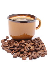 Heap of coffee grains and cup of beverage