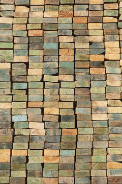 A stack of wood stud boards known as 2 x 4s. Used for construction and scaffolding.