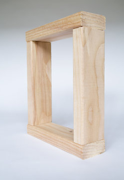 A box shape, four pieces of wood fitted together. Spruce treated  2x4 wood studs, creating a square frame. 