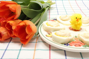Halves of eggs with mayonnaise and Easter decoration