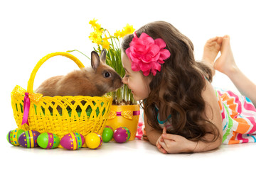 Happy little girl with easter rabbit and eggs