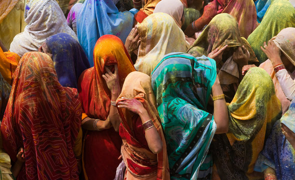 A colourful crowd of people celebrate the Holi Festival, Mathura, Uttar Pradesh, India