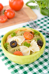 Delicious pasta with tomatoes on plate on table close-up