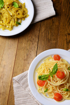 Delicious spaghetti with tomatoes on plate on table close-up