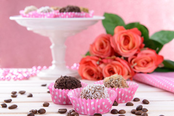 Fototapeta na wymiar Set of chocolate candies on table on pink background