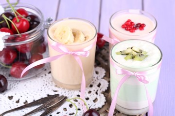 Delicious yogurt with fruits tastes in glasses and fresh fruits