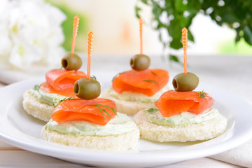 Delicious canapes on table close-up