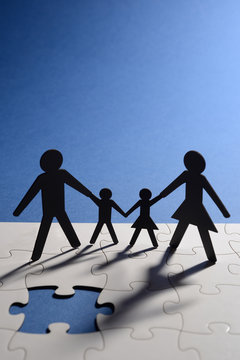 figure of family on jigsaw board