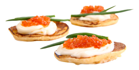 Pancakes with red caviar isolated on white