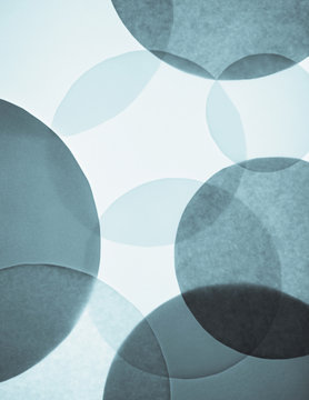 Overlapping circular shapes in various shades of blue.