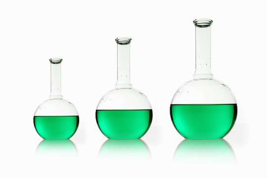 Three rounded shaped scientific chemical flasks holding green liquid, arranged in size order. 