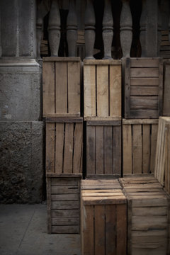 A stack of wooden crates, in the corner of a room. 