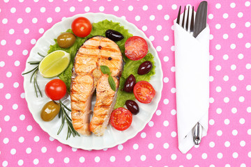 Tasty grilled salmon with vegetables, close up