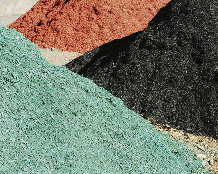 Piles of multi-colored bark wood chips used for landscaping, near Quincy
