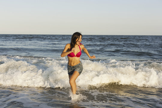 A Beautiful Young Women At The Water's Edge On The Beach In Atlantic City.