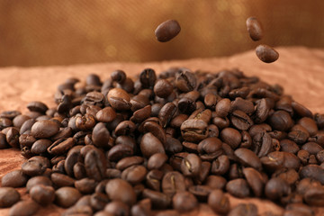 Coffee beans on table on brown background