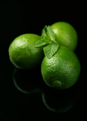 Fresh limes on dark background