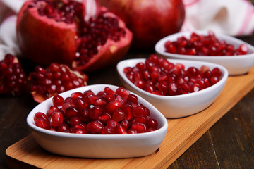 Ripe pomegranates on table close-up