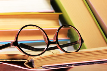 Composition with glasses and books,