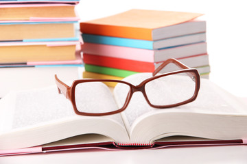 Composition with glasses and books, isolated on white