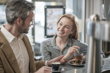 an handsome man meets  a beautiful woman in a cafe