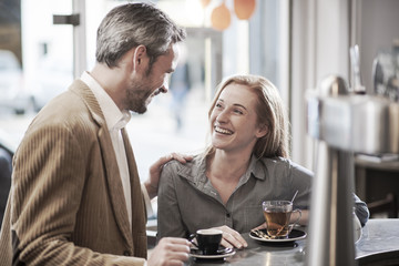 an handsome man meets  a beautiful woman in a cafe