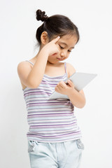 Thinking Asian child with tablet computer