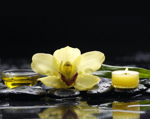 Pink orchid and black stones and candle