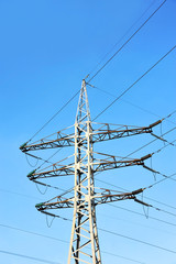 Electric lines pylon on blue sky background