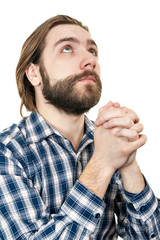 the young man with a beard prays to god