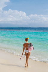 Fototapeta na wymiar Beach woman snorkeling walk happy, enjoying the sun and holidays