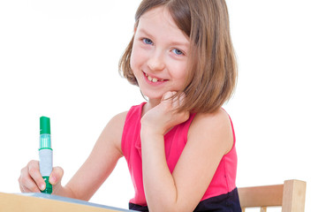 Girl schoolgirl sits at a table