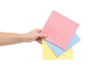 Hand holds different sponges.