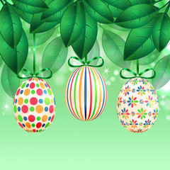 Easter eggs with colorful patterns on a background of spring fol