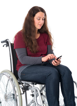 woman in wheelchair using her smartphone