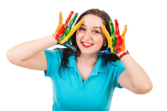 Cheerful woman with hands in paints
