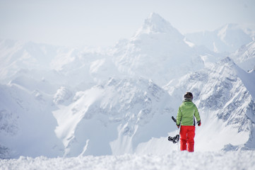 Fototapeta na wymiar Female snowboarder at the mountains