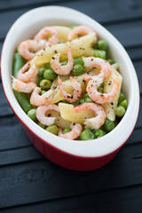 Penne pasta with shrimps, peas and beans, vertical shot