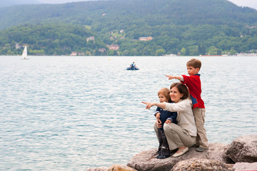 Woman with children on lake brink