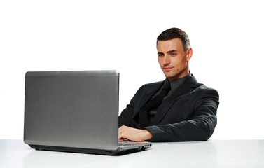 Confident businessman working on laptop 
