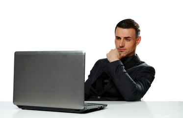 Confident businessman working on laptop