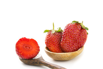 Strawberry on wood spoon.