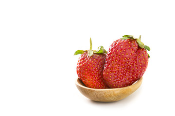 Strawberry on wood spoon.